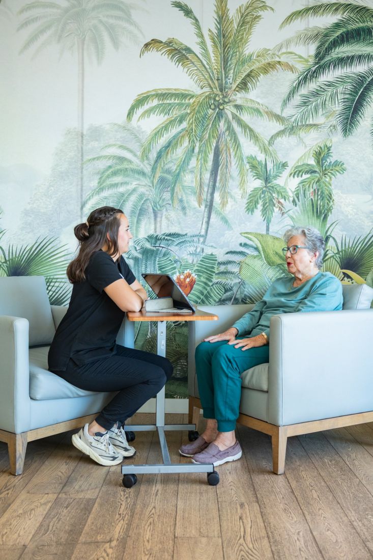 A therapist and an older patient in conversation during a session